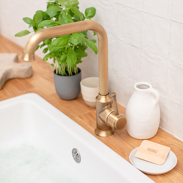 Bamboo Pot Scraper Beside a Sink