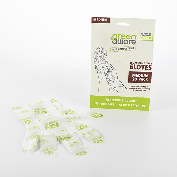 20 pack of medium clear gloves with a pair of clear gloves lying in front