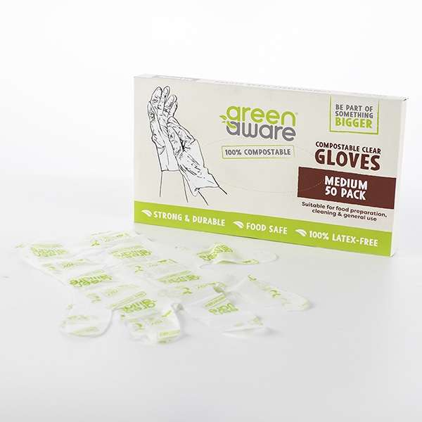 50 pack of medium clear gloves with a pair of clear gloves lying in front