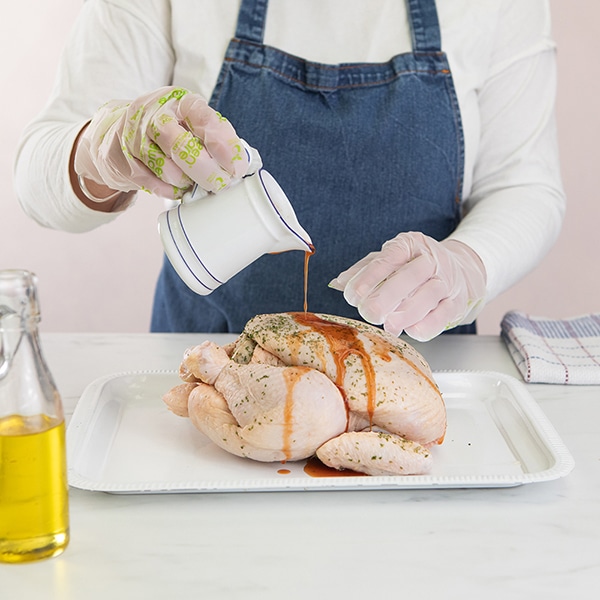 Clear gloves are being worn while handling food