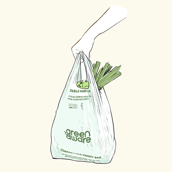 Person at counter using Green Aware compostable reusable handy bags