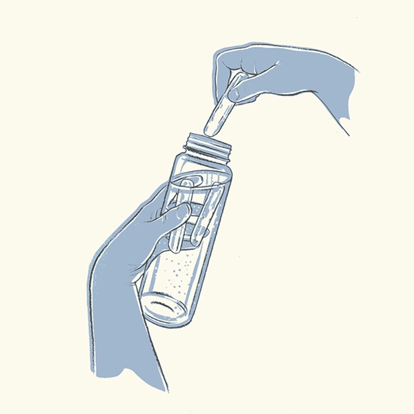 Ice stick being dropped into a bottle of water